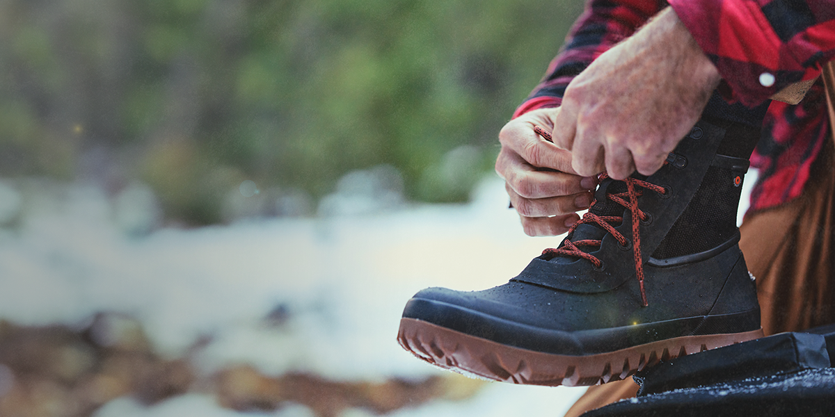 Shop the men's Arcata featuring a man tying the boots.