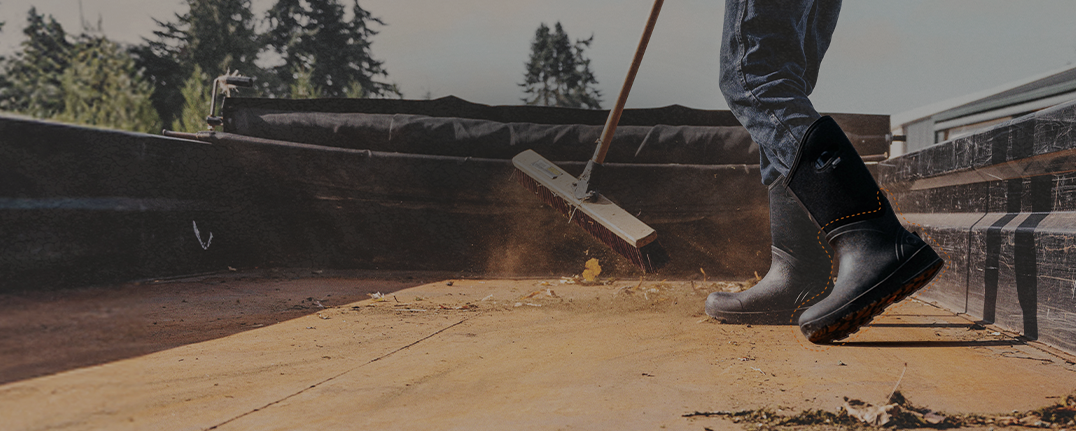 Shop seamless construction featuring a man sweeping out a truck bed.