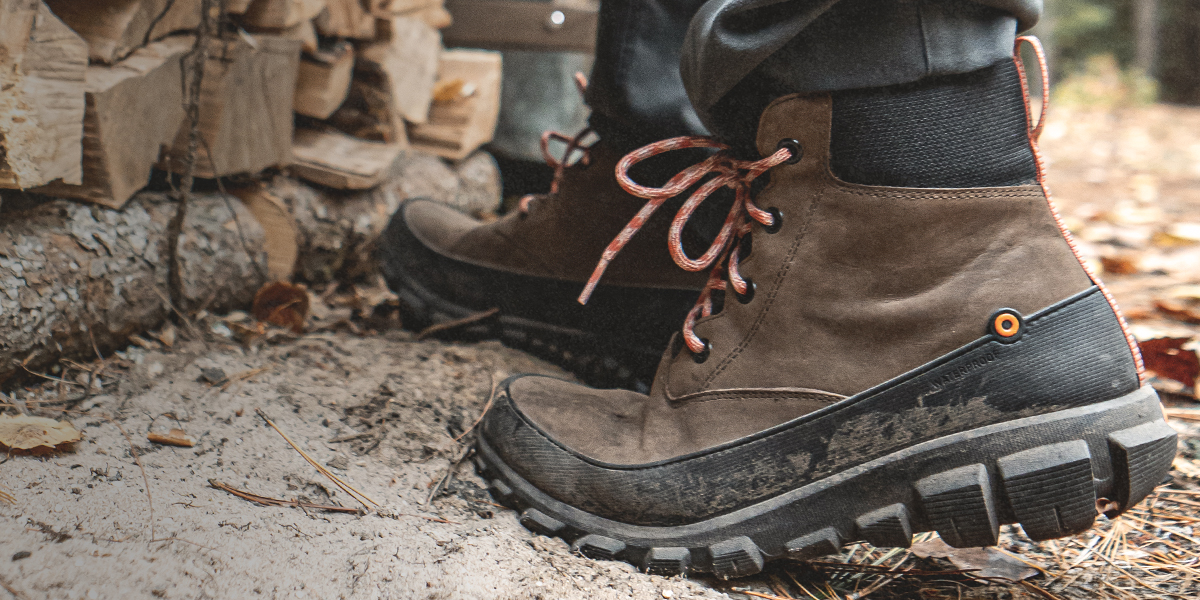 Shop our sale section featuring a brown lace up boot next to a wood pile.