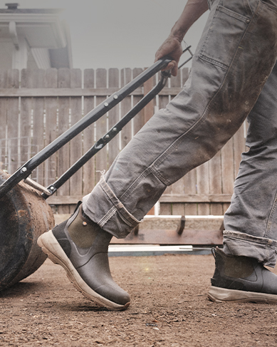 Shop the men's Spruce collection featuring a man walking through the dirt.