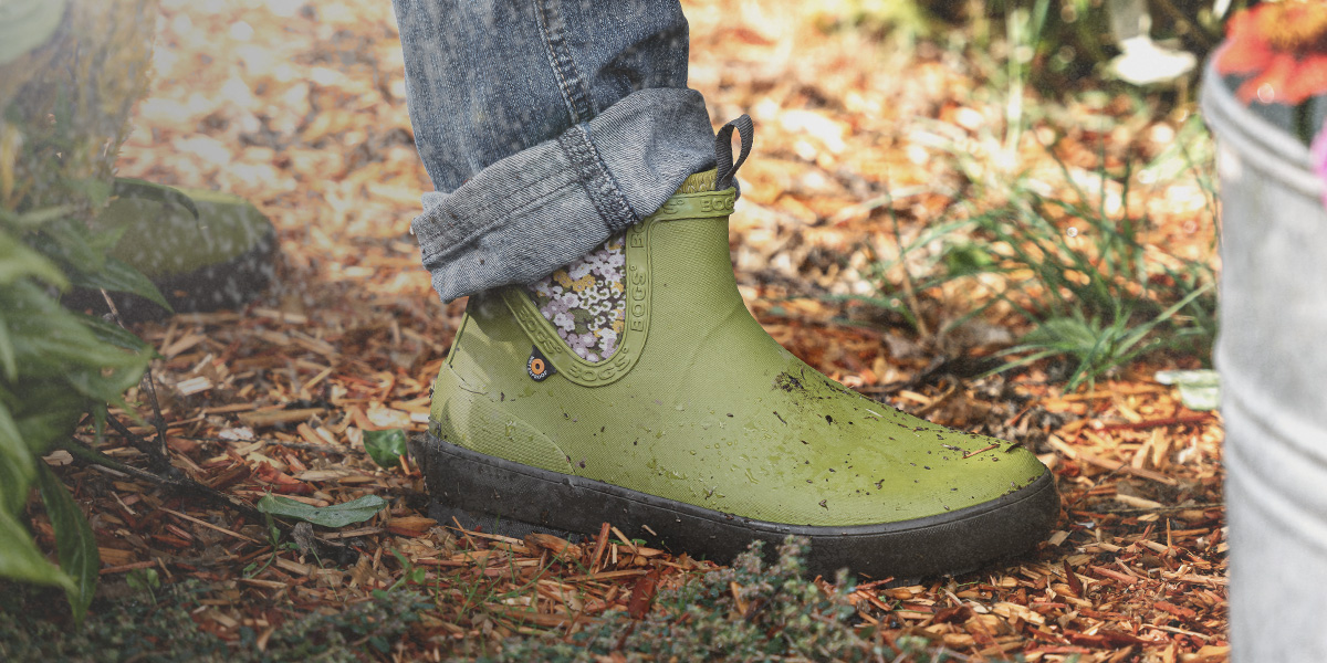 Shop the new Harper featuring the Chelsea Boot in green in a garden.
