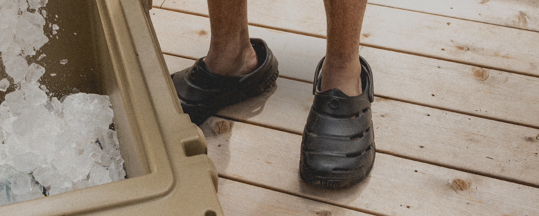 Image features the Boga slip on in black next to a cooler filled with ice.
