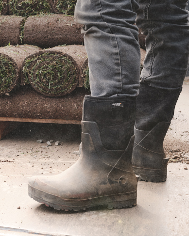 Image features the All Season Mid boot in front of rolls of sod.