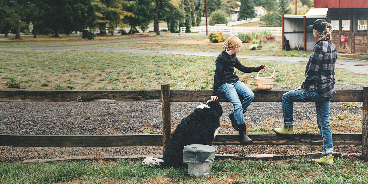 Shop the Mother's Day edit featuring mother, daughter and dog leaning on a fence.
