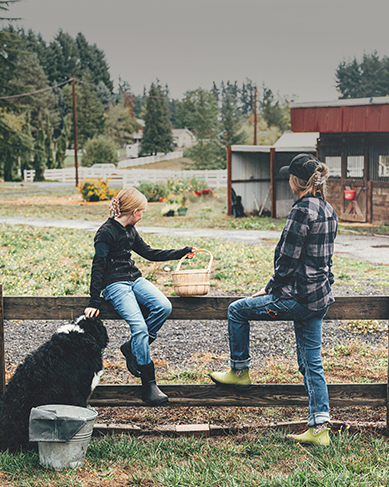 Shop the Mother's Day edit featuring mother, daughter and dog leaning on a fence.