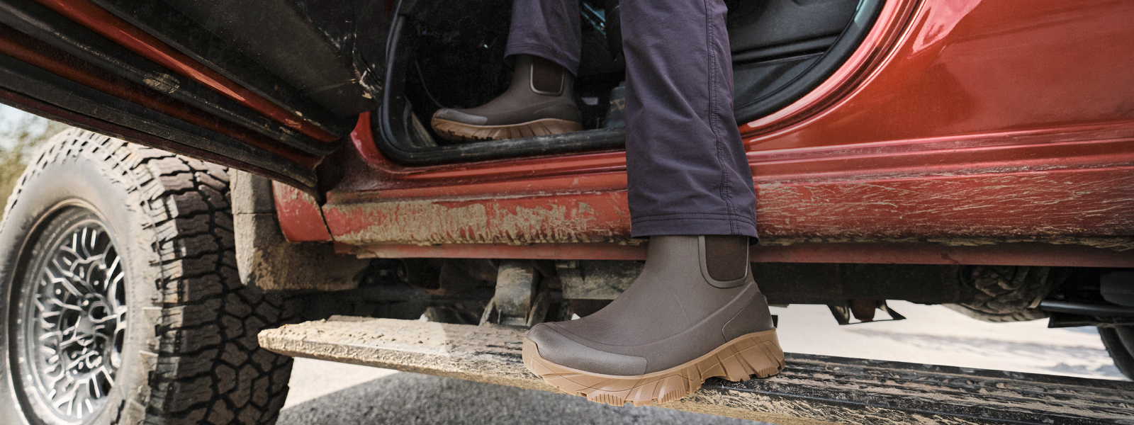 THE NEXT GENERATION OF COLD-WEATHER COMFORT. THE ARCATA II HAS ARRIVED. Image shows a man stepping out of a truck with his Arcata II boots on.