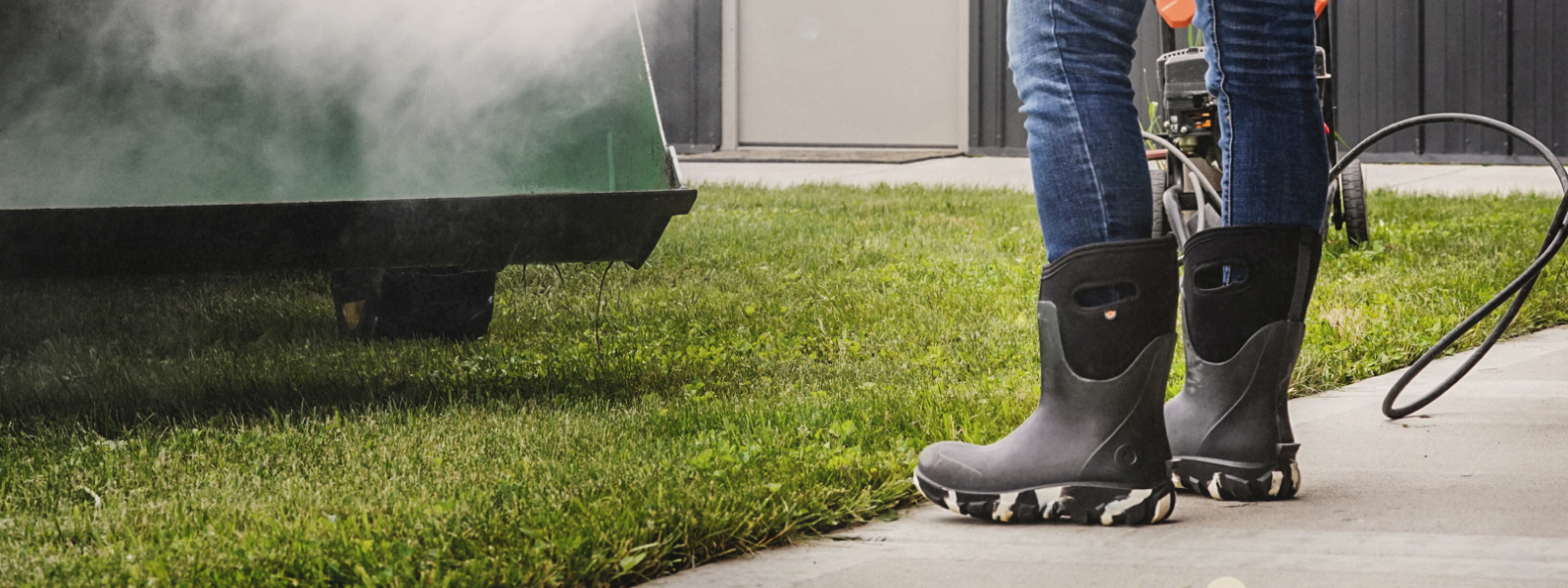 Shop Our Labor Day Sale featuring a women in her classic seamless spraying a tractor down