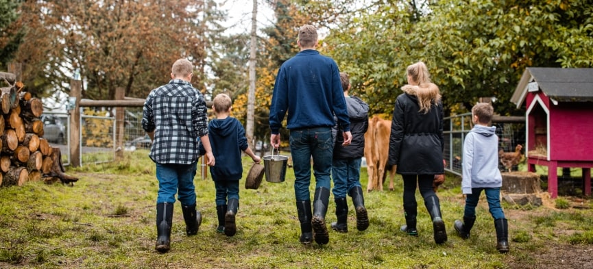 Support 4-H. We do. The image shown are kids walking to toward the cows on the farm to feed them.  Click this image to shop all of our 4-H boots.