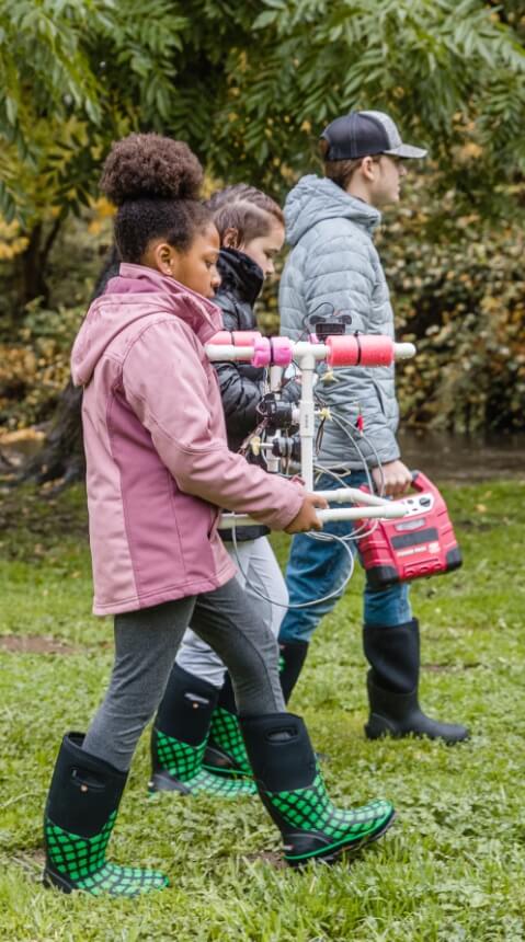 The picture shown are three 4-h students holding a water contraption used for an experiment they are conducting. BOGS is committed to supporting outdoor education efforts to get kids outside to play, learn, and grow.