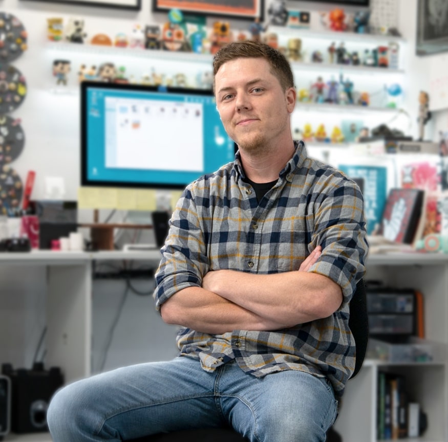 Watch the video and learn more about the artist behind the Kids' dragon rain boots.  This is a picture of Jason Heglund an illustrator in his studio.